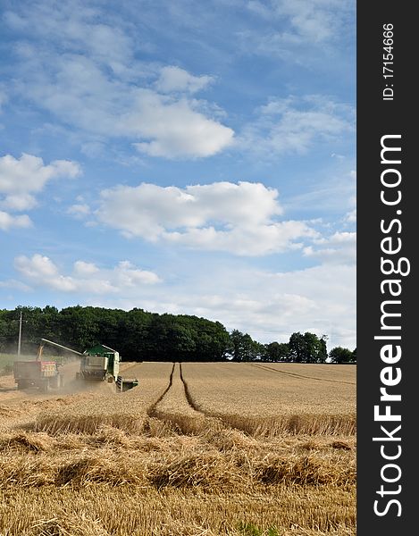 Farmers at work harvesting with tractors