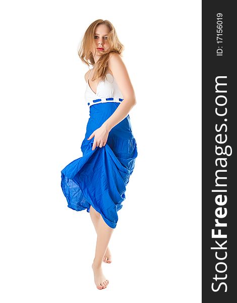 Barefooted girl in a blue dress isolated on a white background