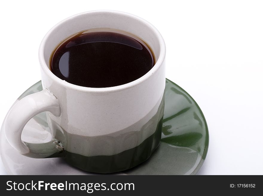 Ceramic mug and saucer with greyish green for hot drinks.