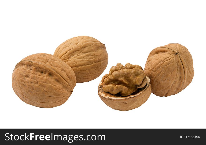 Three whole and half walnuts, isolated on white background.
