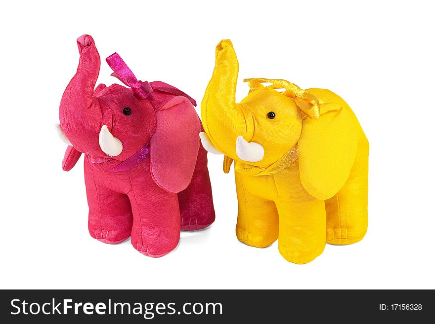 A pair of colorful toy elephants standing on a white background. A pair of colorful toy elephants standing on a white background