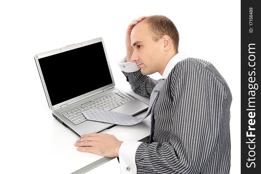 Young worried businessman with a laptop