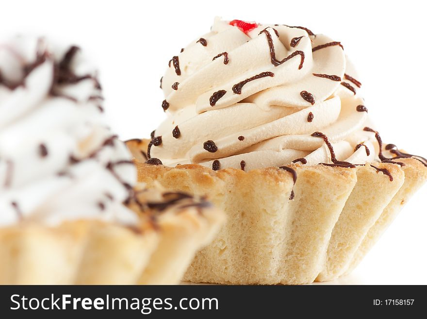 Macro view of cake with whipped cream isolated over white