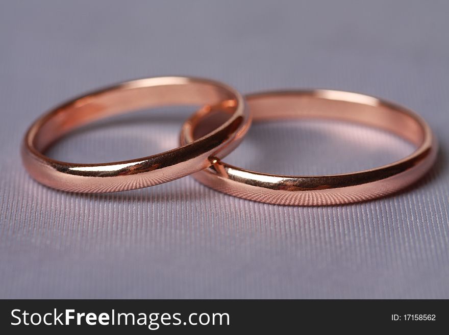 Closeup wedding rings on silk background