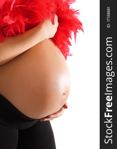 Pregnant woman holding her belly and feather