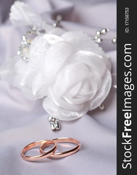 Wedding rings on silk background