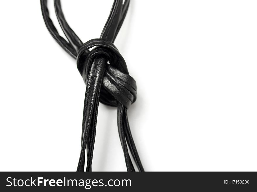 Black leather straps tied in a knot. Black leather straps tied in a knot