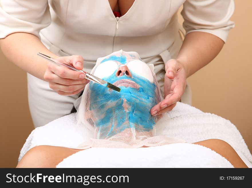 Face of women getting a spa treatment mask