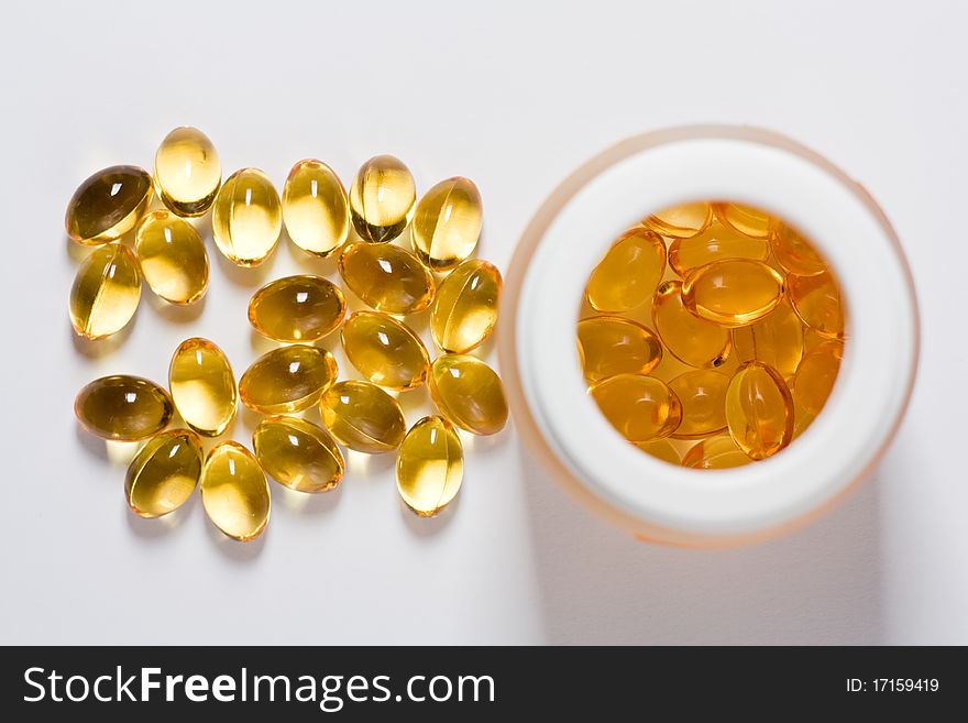 Yellow tablets with a tube on a white background