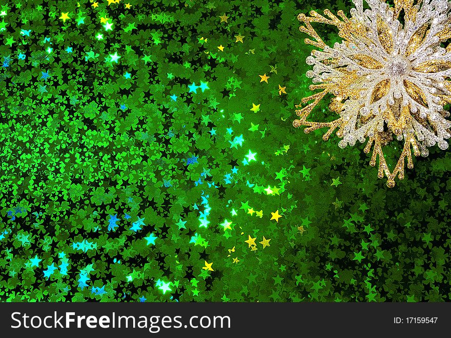 Gold snowflake on a green starry background. Gold snowflake on a green starry background.