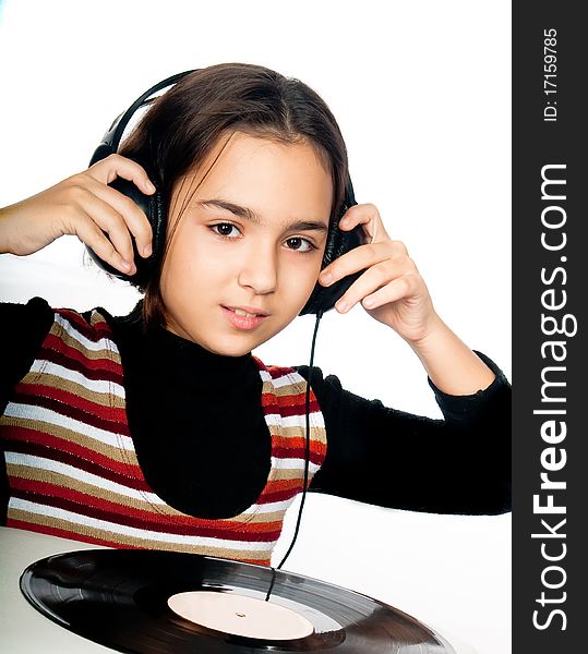 Photo portrait of beautiful preschool child with headphones and plate isolated on white background
