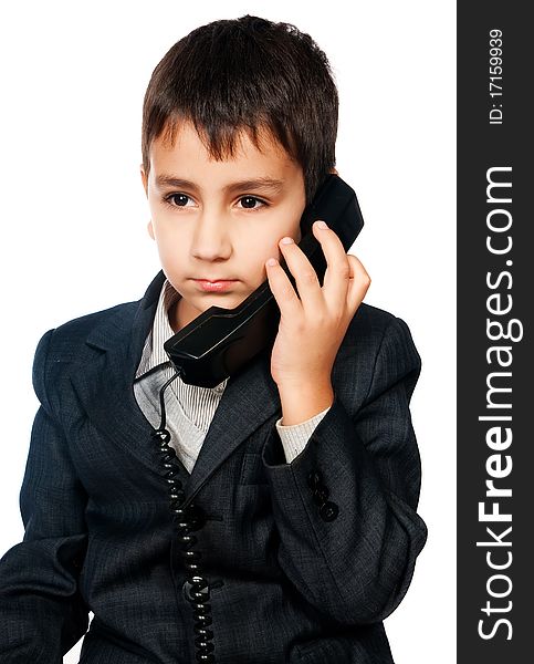 Young boy talking on the phone isolated on white background