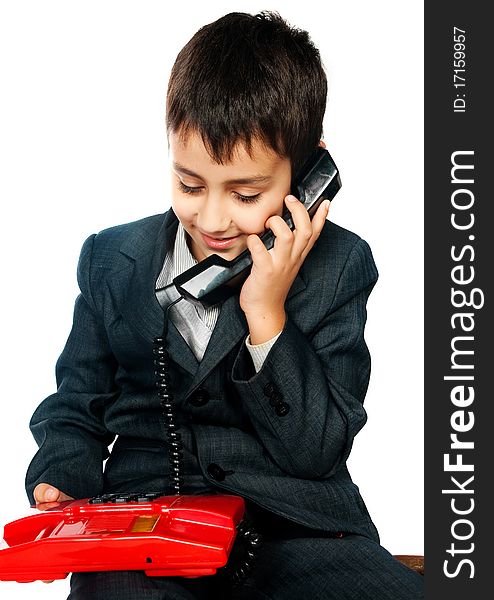 Young boy talking on the phone isolated on white background