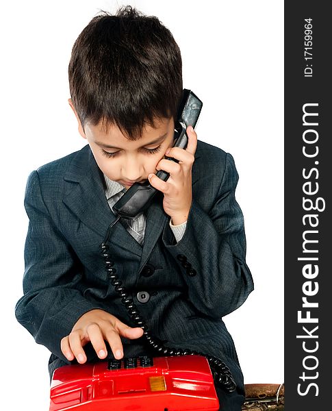 Young boy talking on the phone isolated on white background