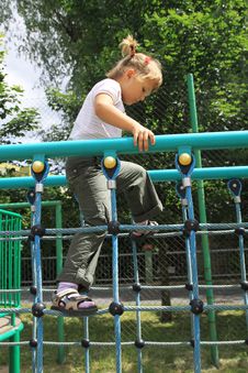 A Girl Walking On The Ladder At The Playground Stock Image
