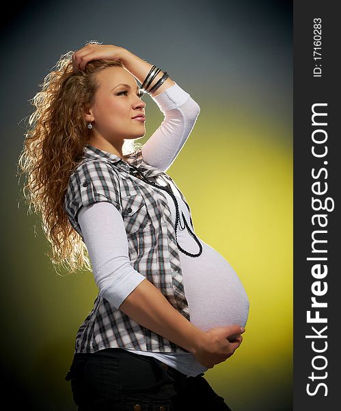 Beautiful pregnant woman in the studio