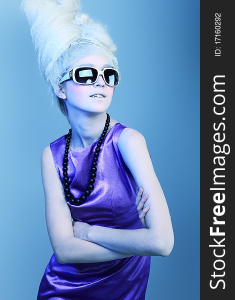 Portrait of a fashionable woman in sunglasses. Studio shot. Portrait of a fashionable woman in sunglasses. Studio shot.