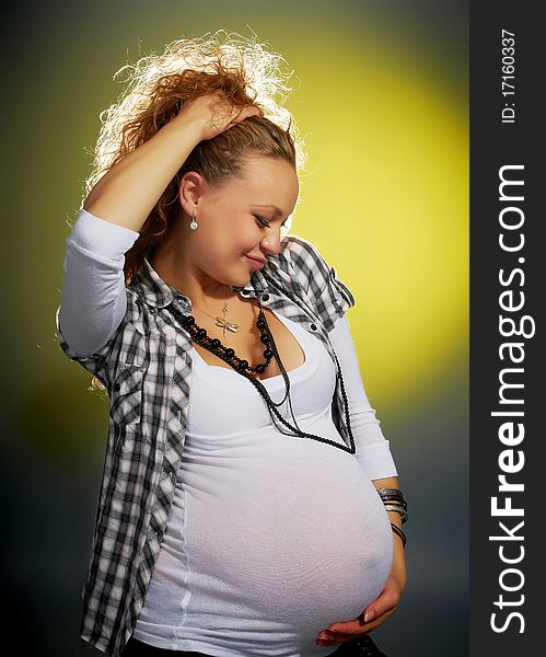 Beautiful pregnant woman in the studio