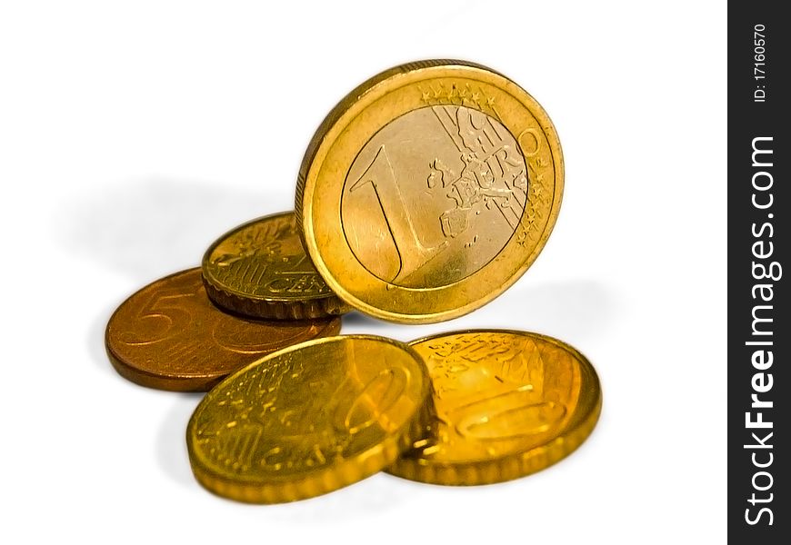 Euro coins, one stands on the edge. Euro coins, one stands on the edge