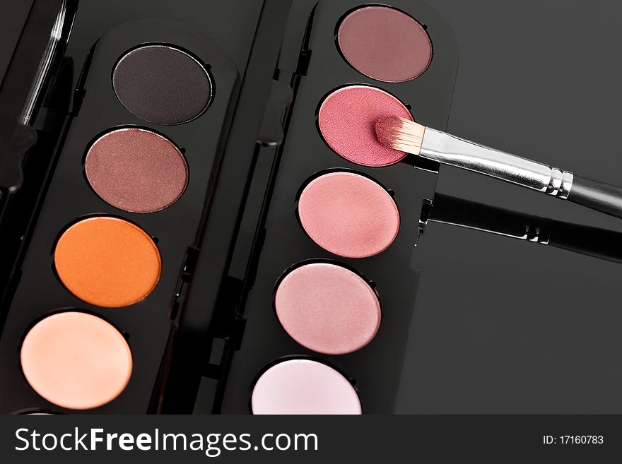 Make-up eyeshadows and cosmetic brush