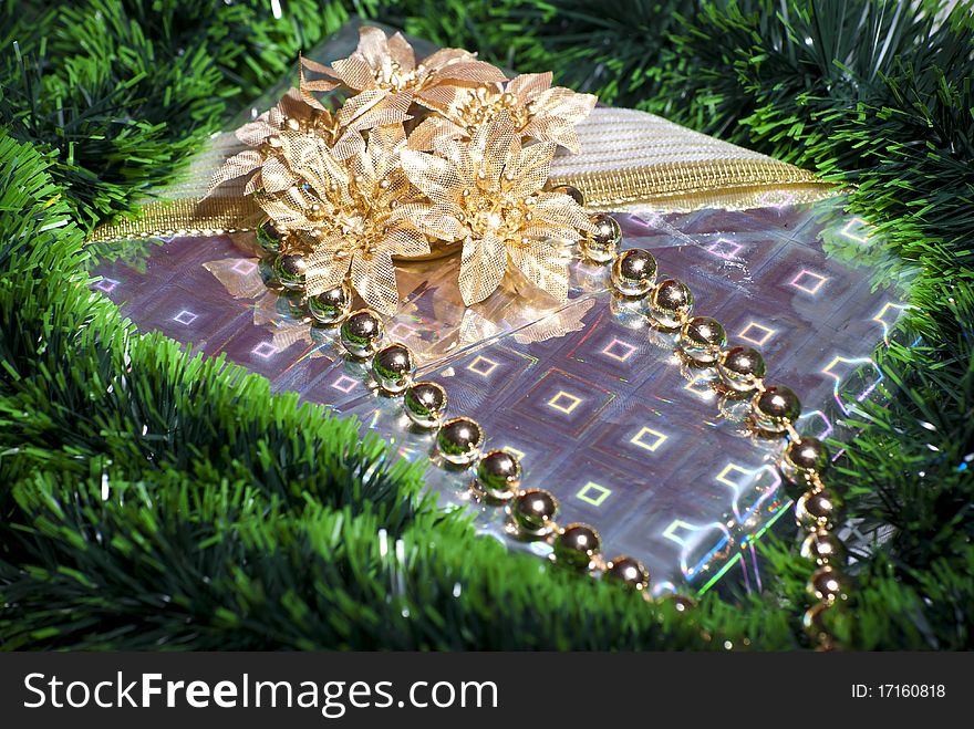 Beautifully wrapped gift box with gold flowers and ribbons