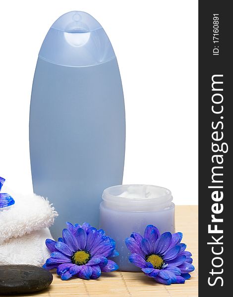 Spa essentials, cream and towel with blue flowers