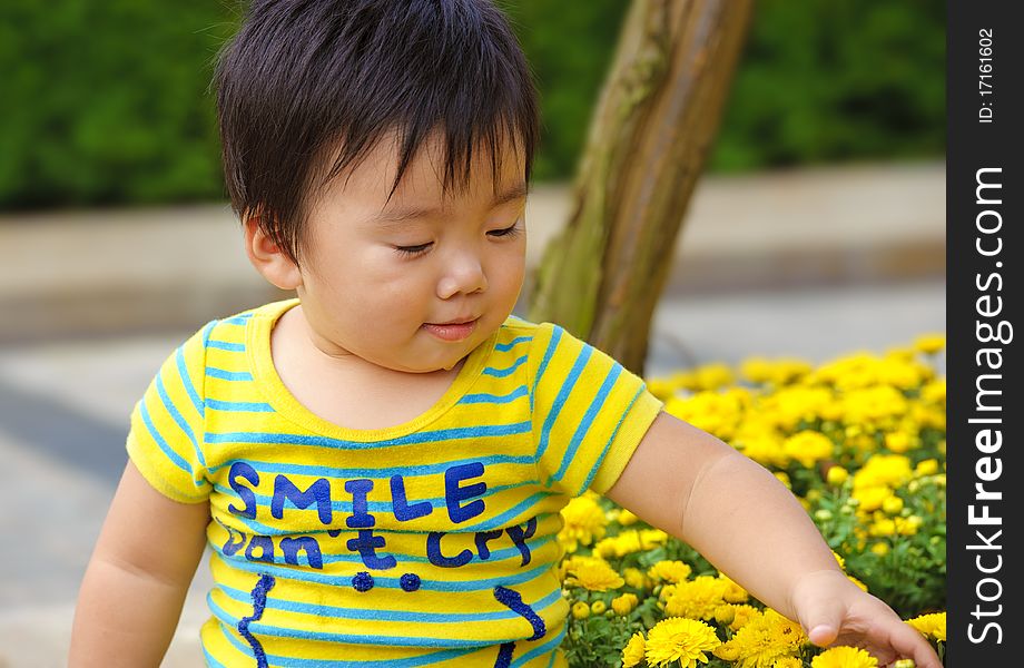 A cute baby is playing in garden