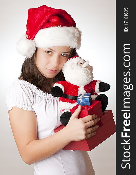 Teenager with santa red hat and gifts for christmas. Teenager with santa red hat and gifts for christmas