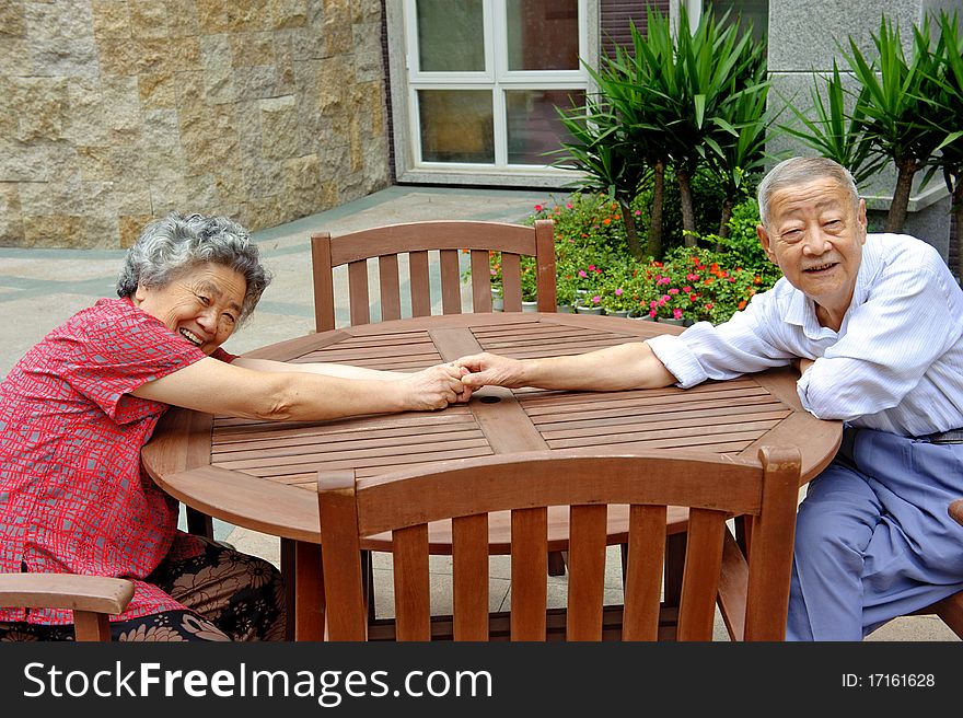 An intimate senior couple in a park. An intimate senior couple in a park