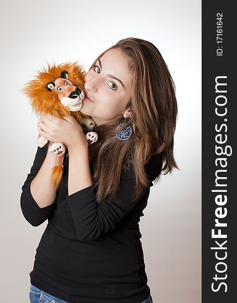 Teenager with her lion toy. Teenager with her lion toy