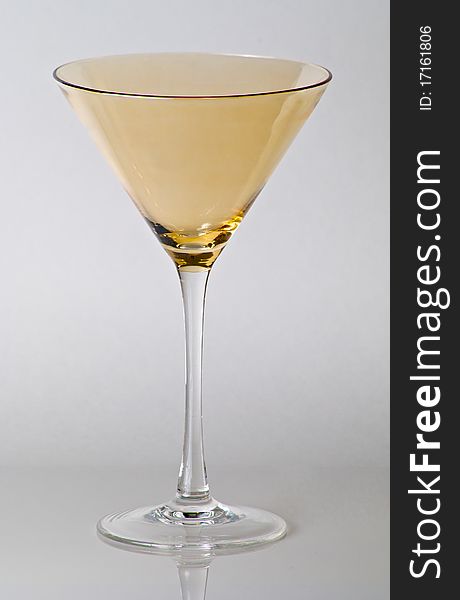 Yellow top martini glass on white background.