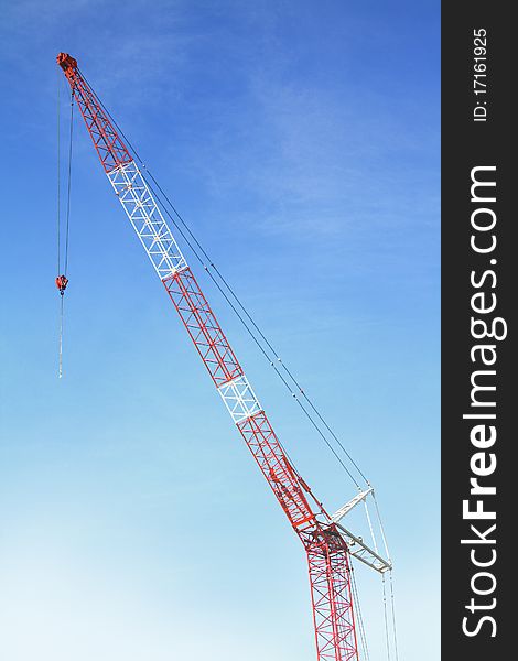 Red & Blue hoisting crane isolate with sky. Red & Blue hoisting crane isolate with sky