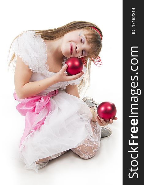 Small cheerful girl plays with Christmas red ball