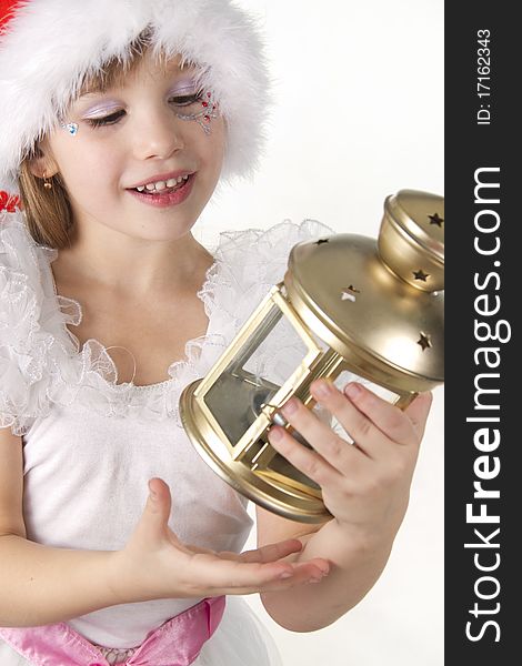 Little girl Santa holds a Christmas lantern being surprised. Little girl Santa holds a Christmas lantern being surprised