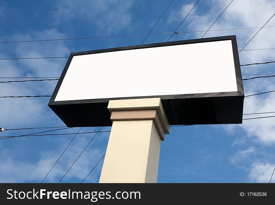 Blank white commercial store sign against blue sky. Blank white commercial store sign against blue sky