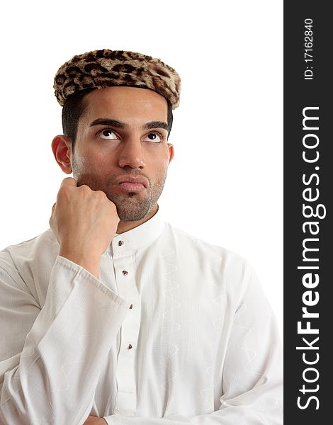 An ethnic man wering a white embroidered robe fastened with claw set rubies and wearing vintage leopard skin hat. He is looking up and thinking or pondering. Space for copy. White background. An ethnic man wering a white embroidered robe fastened with claw set rubies and wearing vintage leopard skin hat. He is looking up and thinking or pondering. Space for copy. White background.