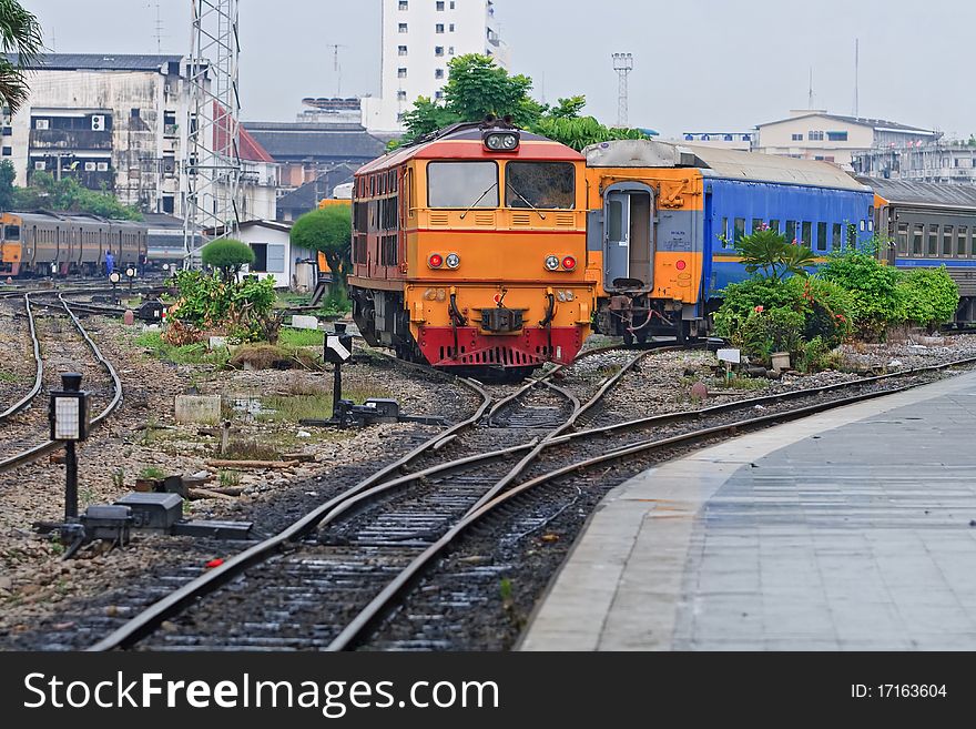 Closeup of Red Yellow Diesel Engine Train locomotive approaching to Bangkok Railway Station Thailand. Closeup of Red Yellow Diesel Engine Train locomotive approaching to Bangkok Railway Station Thailand