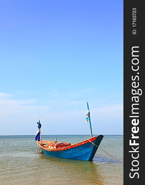 Lonely fisherman long tail boat park at the Rayong beach Thailand, vertical