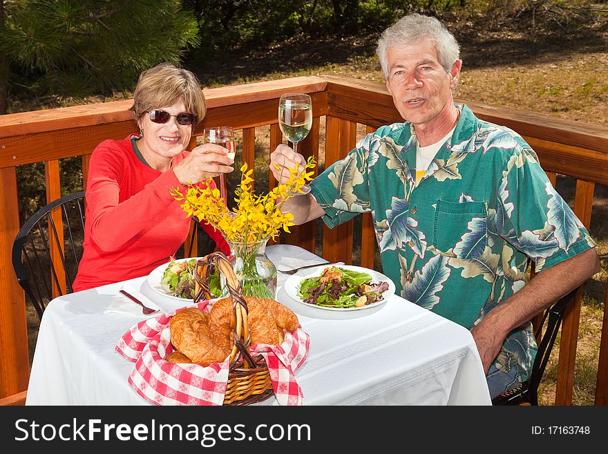 Happy middle aged couple dining at an outdoor cafe. Happy middle aged couple dining at an outdoor cafe.