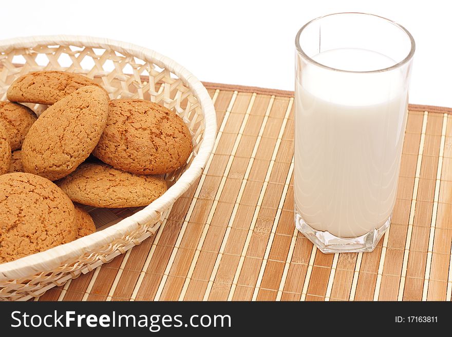Oatmeal cookies and milk in a glass substrate at a straw