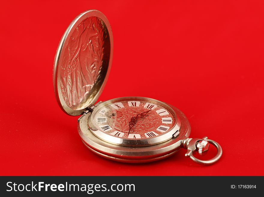Old pocket watch on red background. Old pocket watch on red background