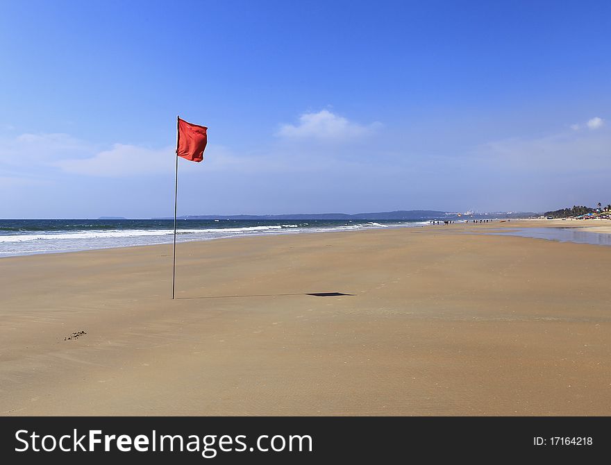 Red flag in a solitaire beach. Red flag in a solitaire beach