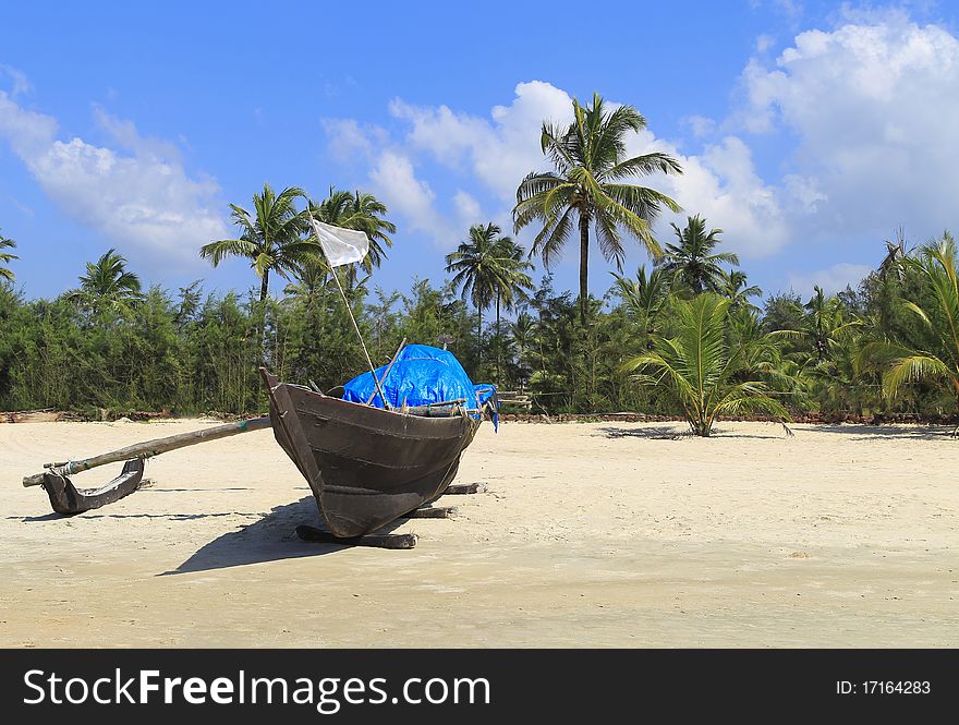 Small coastal fishing boat in the a beach of goa in india. Small coastal fishing boat in the a beach of goa in india
