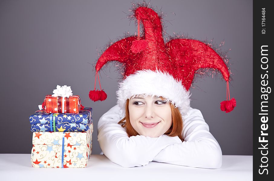 Funny red-haired girl in christmas cap