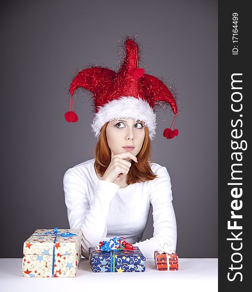 Funny red-haired girl in christmas cap