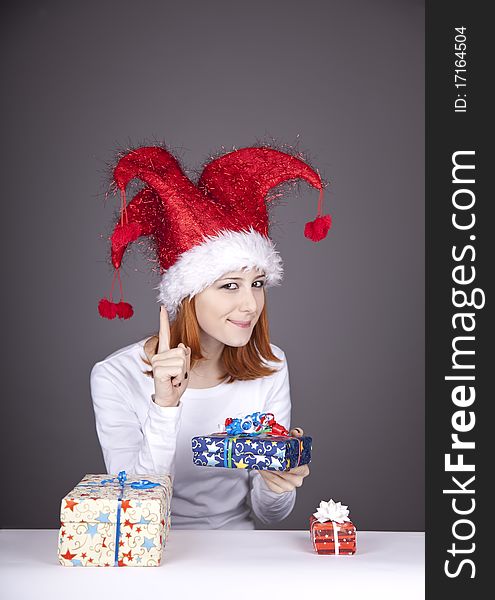 Funny red-haired girl in christmas cap