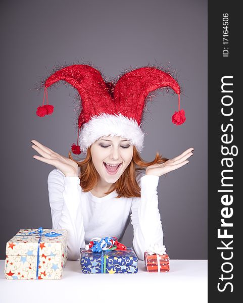 Funny red-haired girl in christmas cap