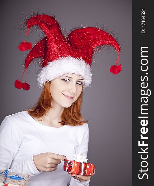 Funny red-haired girl in christmas cap