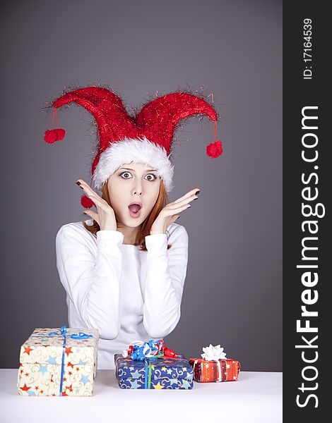 Surprised red-haired girl in christmas cap