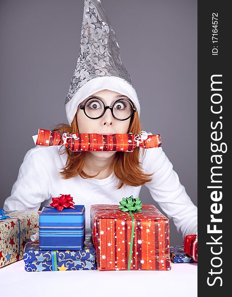 Surprised red-haired girl in christmas cap